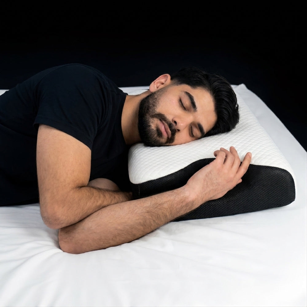 A side sleeper with the lower shoulder tucked into the arm slot recess
